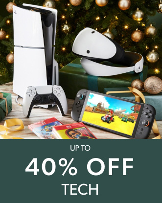PlayStation 5 console, VR headset, Nintendo Switch 2, and games displayed near a decorated Christmas tree.