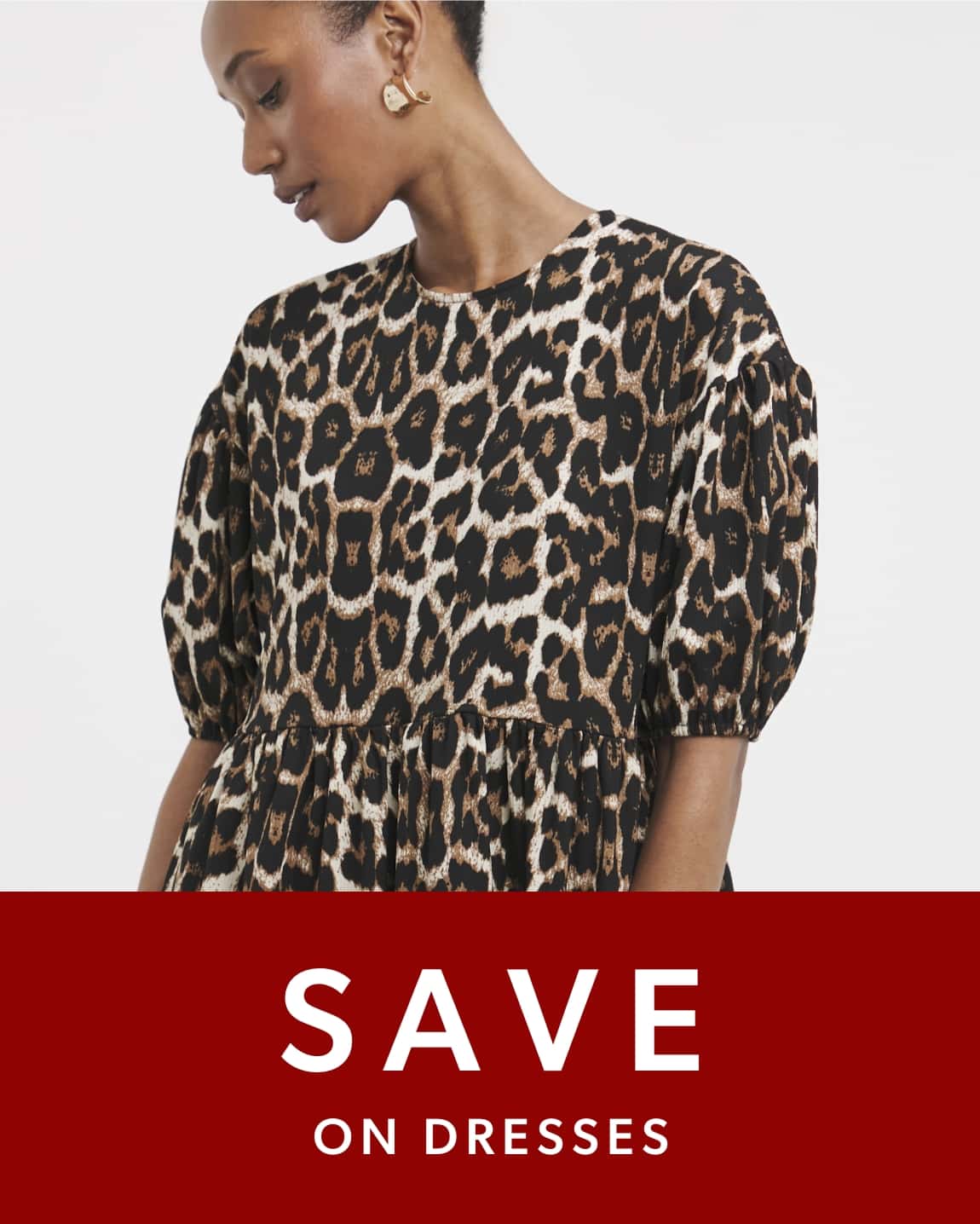 Person wearing a leopard-print dress with puffed sleeves.