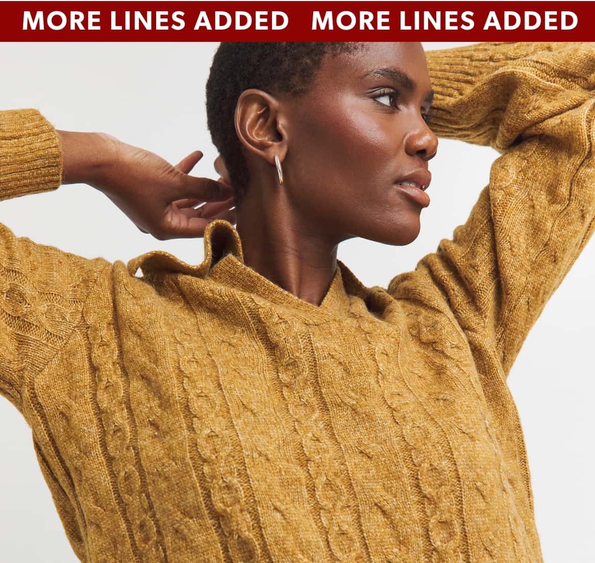 A model wearing a tan-coloured jumper.