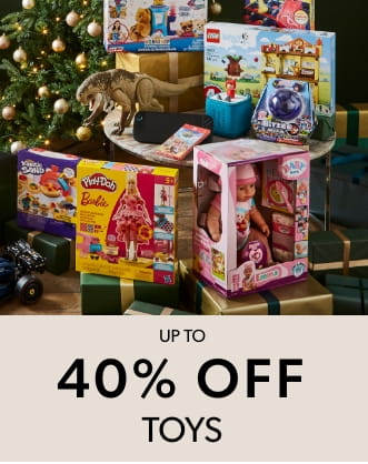 A festive display of toys including Play-Doh Barbie, LEGO sets, and a doll set, with a decorated Christmas tree in the background.