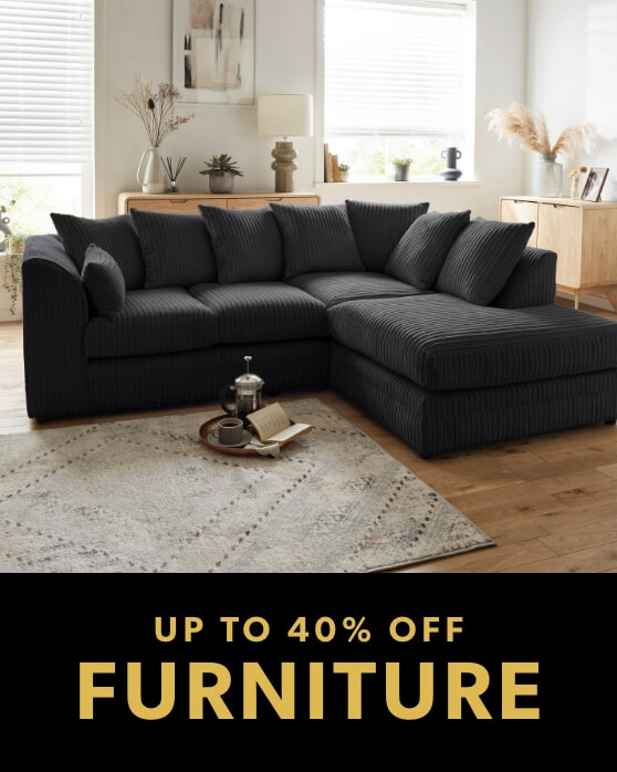 Promotional banner featuring a large, dark grey corduroy corner sofa in a bright, modern living room setting.