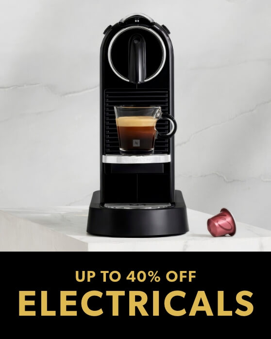 Promotional banner displaying a black Nespresso coffee machine brewing coffee into a clear glass cup on a marble surface.